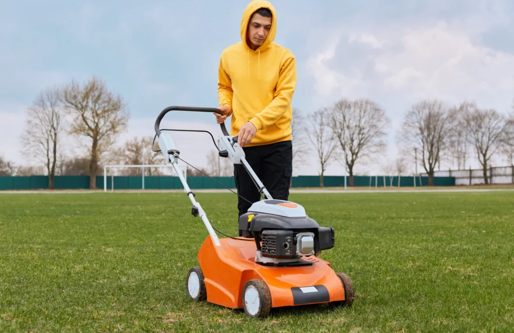 Draw an illustration of a vibrant synthetic grass lawn being maintained with gardening tools