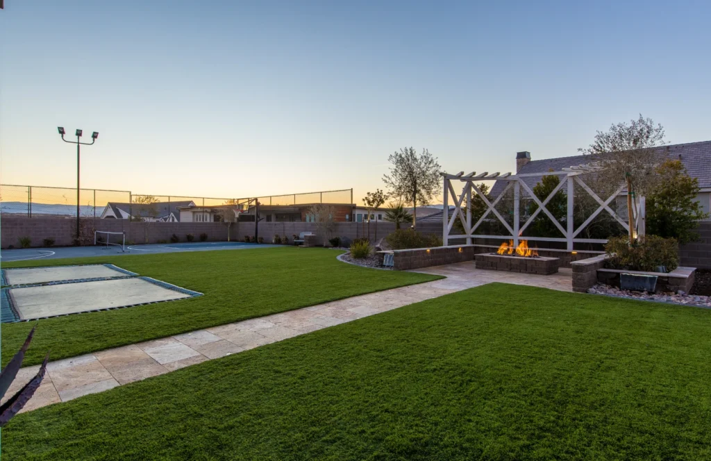 An expansive high school sports field featuring vibrant green artificial turf