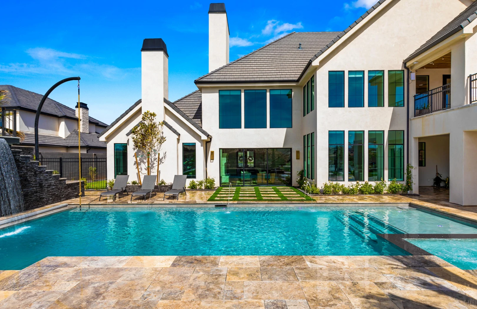 A vibrant residential backyard featuring lush synthetic turf